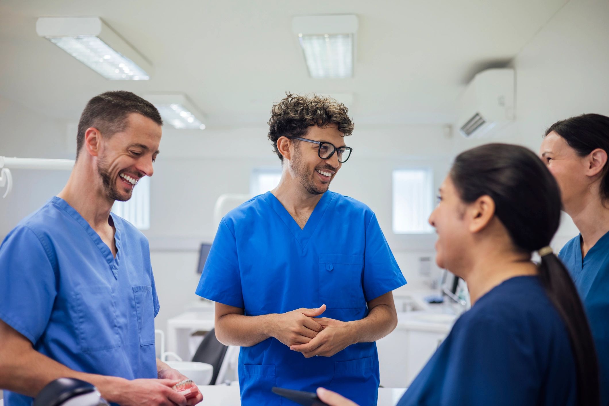 Healthcare professionals in scrubs discussing training